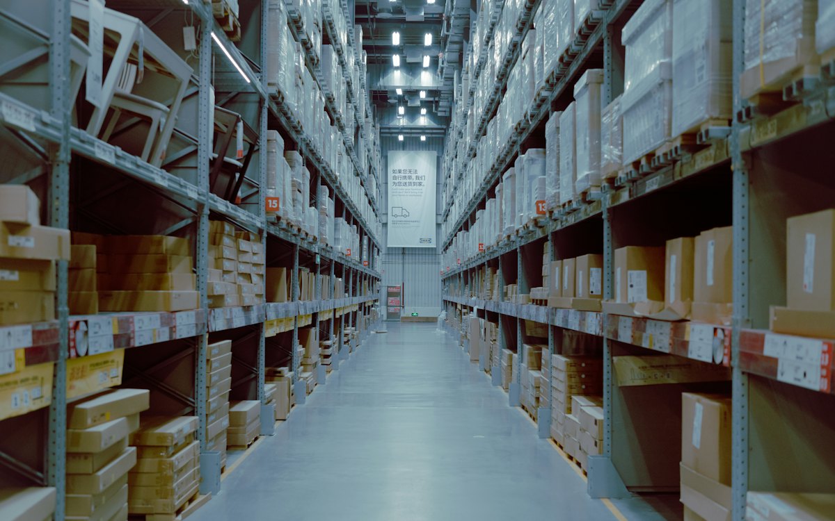 Rows of stocked shelving in a large warehouse