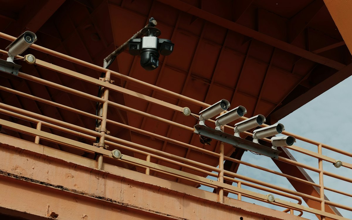 Security cameras mounted on an orange steel frame